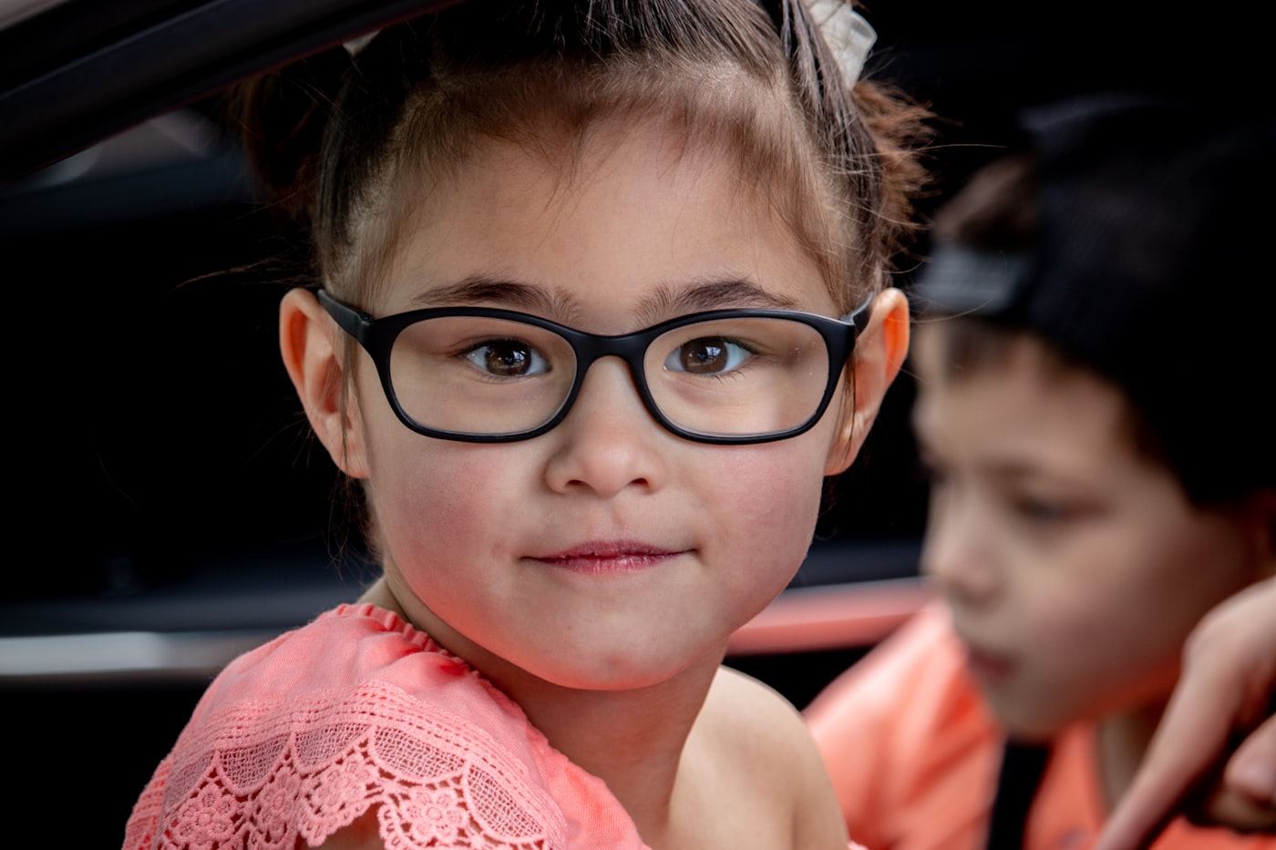 Young girl happily wearing her new glasses